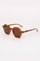 Brown sunglasses with tortoiseshell frame on a white background