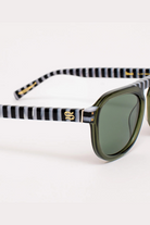 Sunglasses with striped black and white arm design on a white background