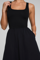 Black sleeveless dress on a plain background