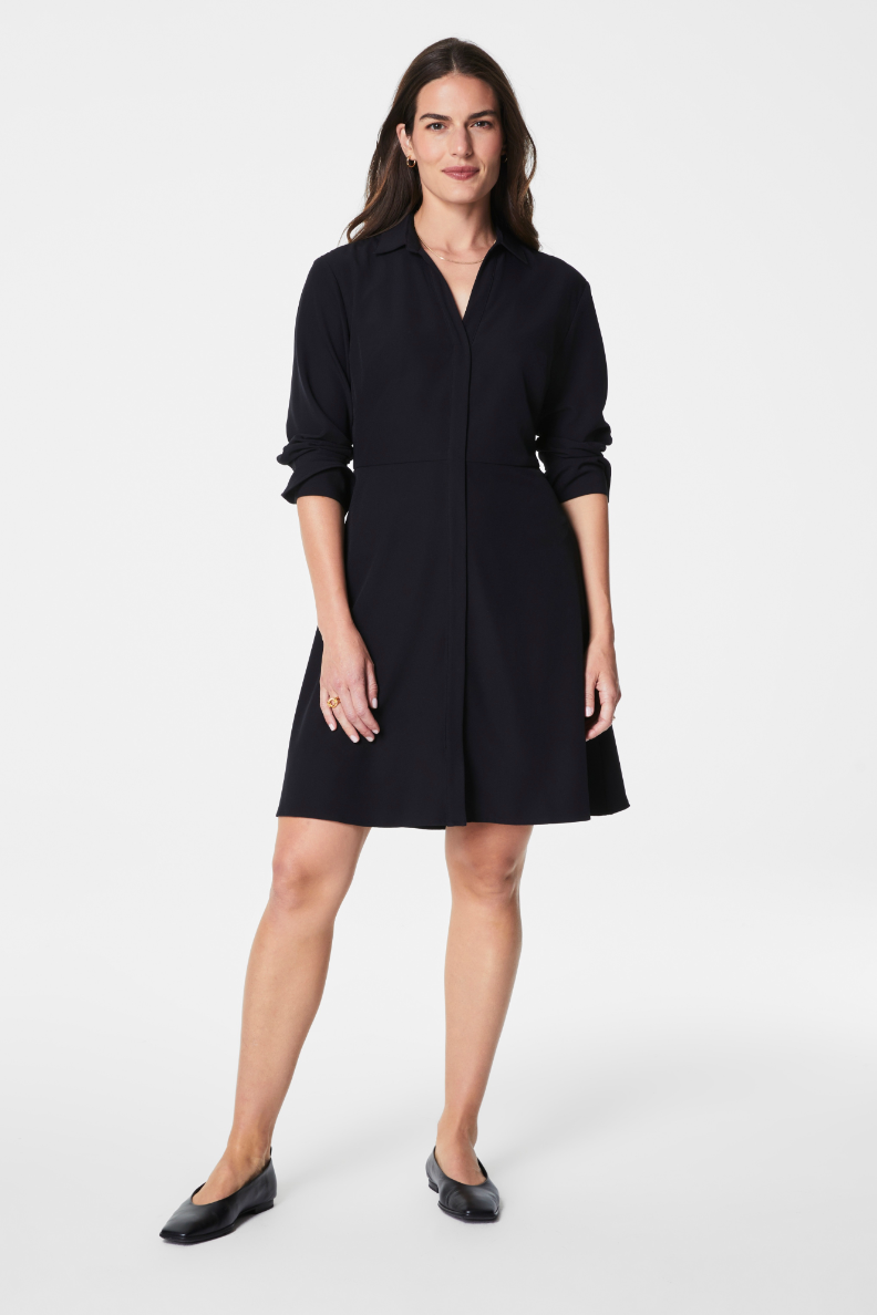 Woman wearing a black dress on a white background