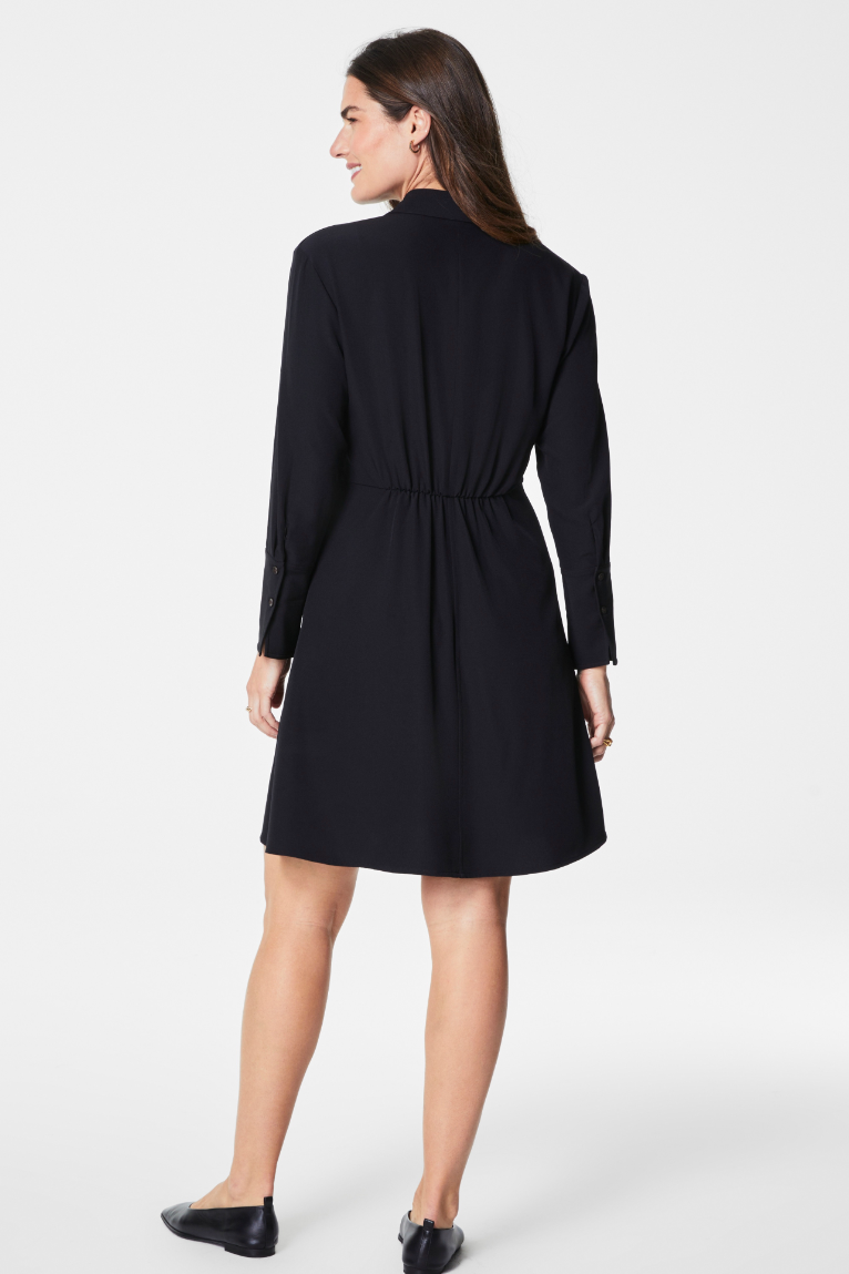 Woman wearing a black dress on a white background