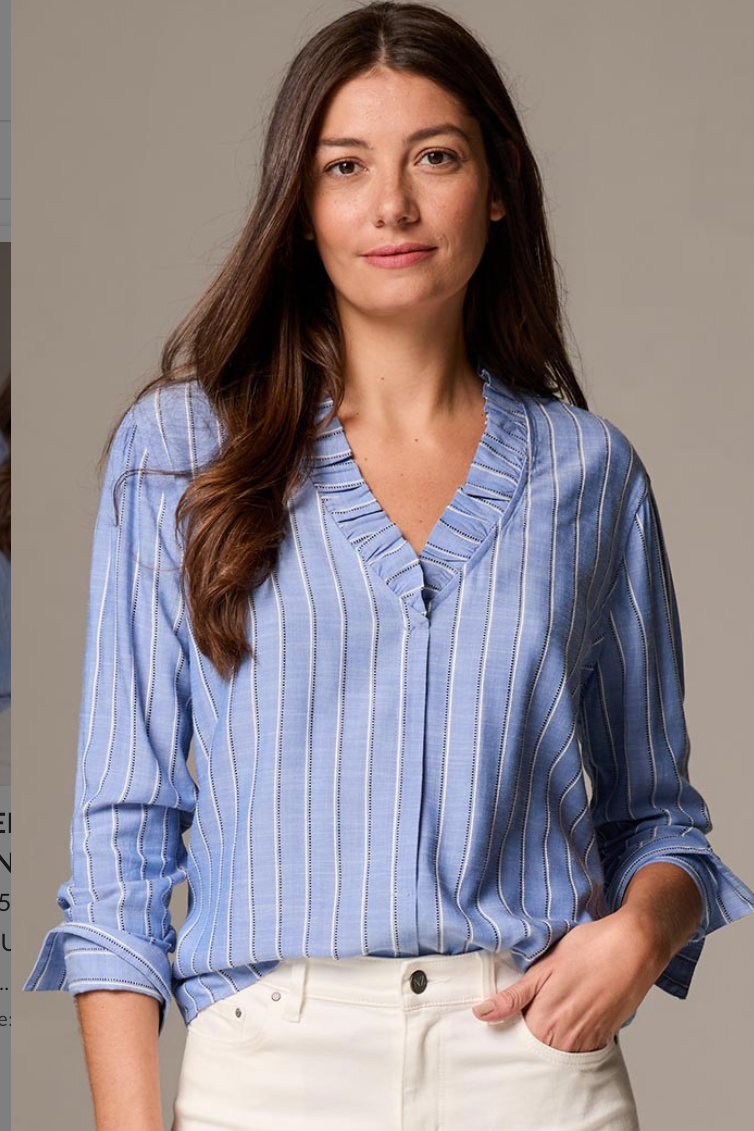 Woman wearing a blue striped shirt against a neutral background