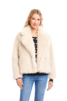 Woman wearing a cream fur jacket on a white background