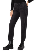 Person wearing black jeans and black boots on a white background