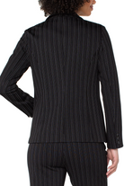 Black pinstripe suit jacket worn by a person on a white background