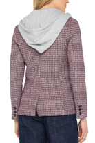 Person wearing a textured jacket with a hood on a white background