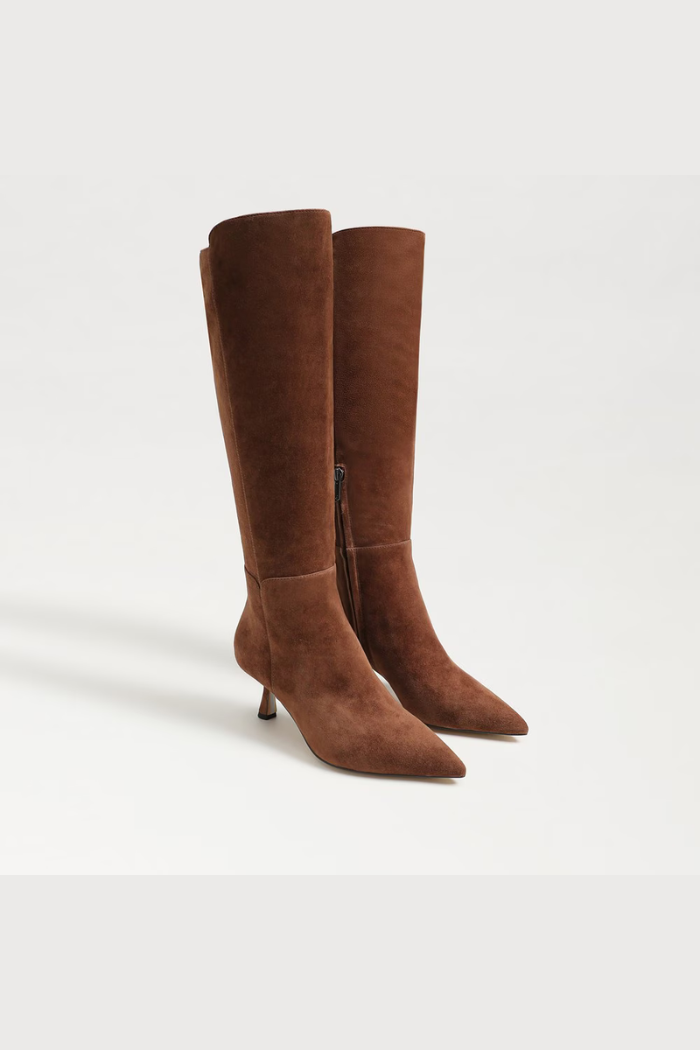 Pair of brown knee-high boots on a white background