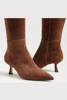 Pair of brown knee-high boots on a white background