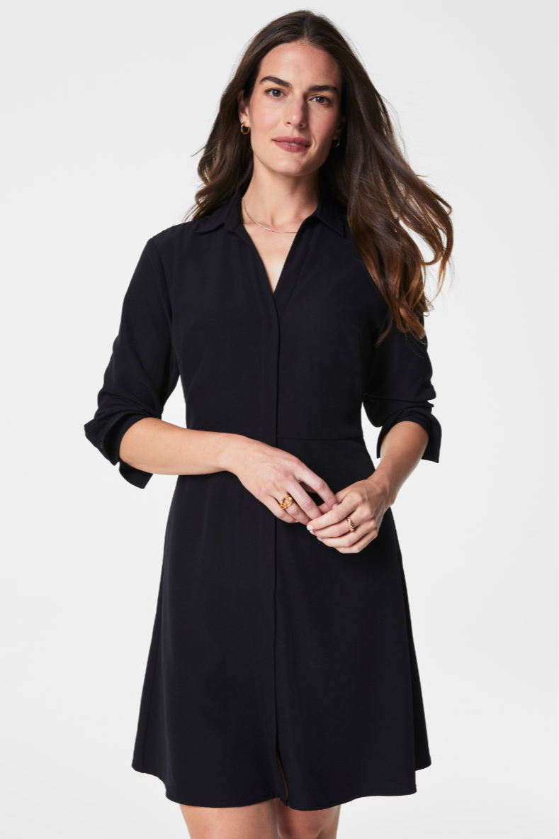 Woman wearing a black dress against a white background