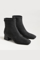 Pair of black ankle boots on a white background