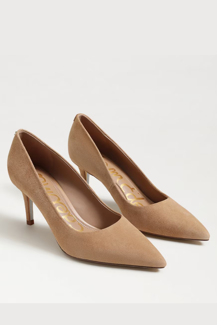 Pair of beige high-heeled shoes on a light gray background