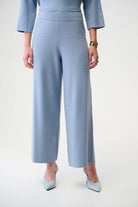 Light blue outfit with wide-leg pants and matching top on a white background