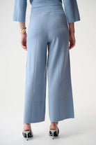 Light blue outfit with wide-leg pants on a plain background