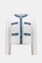 White cardigan with denim accents on a white background