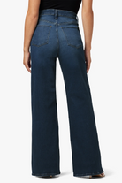 Blue jeans worn by a person on a white background