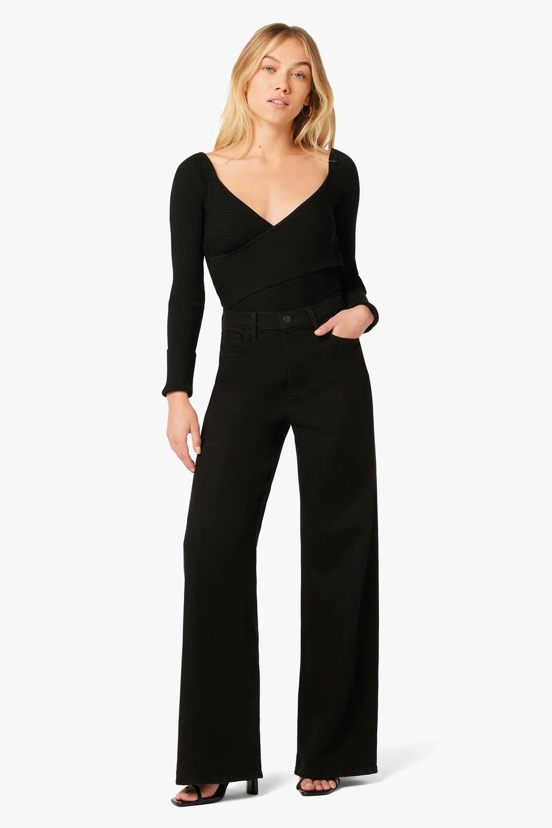 Woman wearing a black jumpsuit on a white background