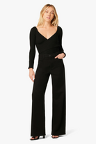 Woman wearing a black jumpsuit on a white background