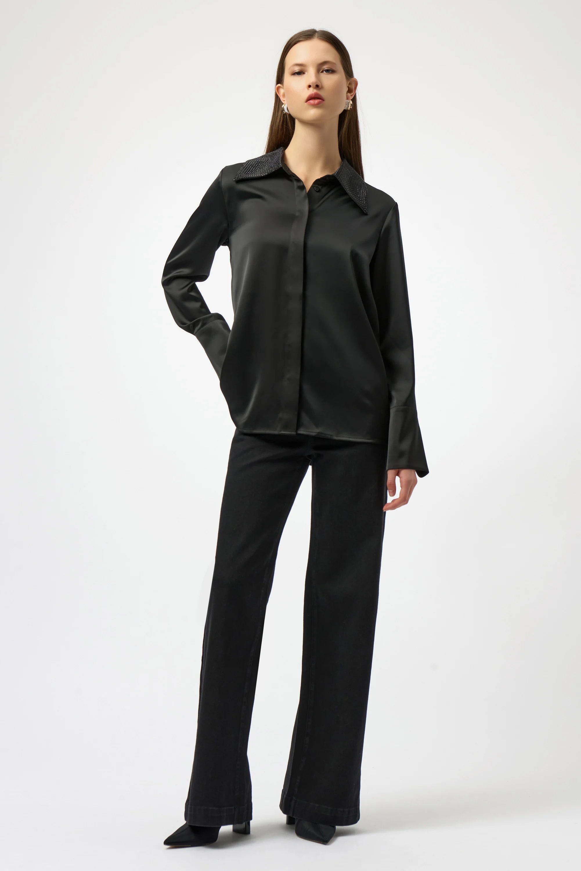 Woman wearing a black shirt and pants on a white background