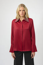 Woman wearing a red blouse with a white background