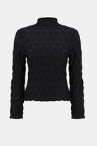 Black turtleneck sweater on a light gray background