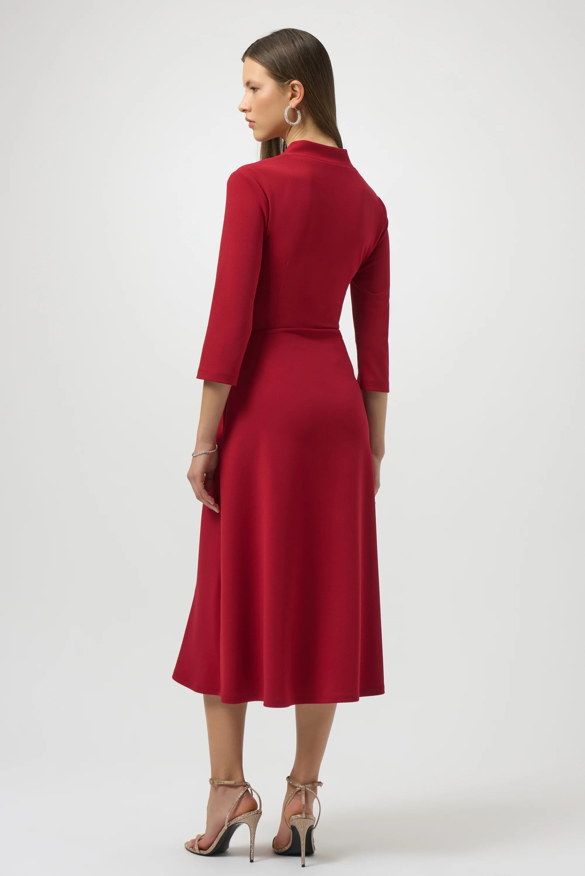 Red dress worn by a model on a white background
