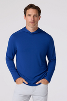 Man wearing a blue long-sleeve shirt against a white background