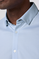 Light blue checkered shirt with a collar detail on a neutral background