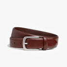 Brown leather belt with a silver buckle on a white background