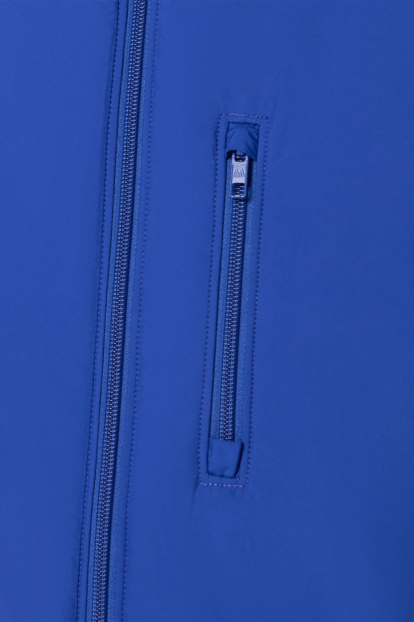 Close-up of a blue jacket with a zipper and brand label.