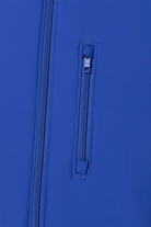 Close-up of a blue jacket with a zipper and brand label.
