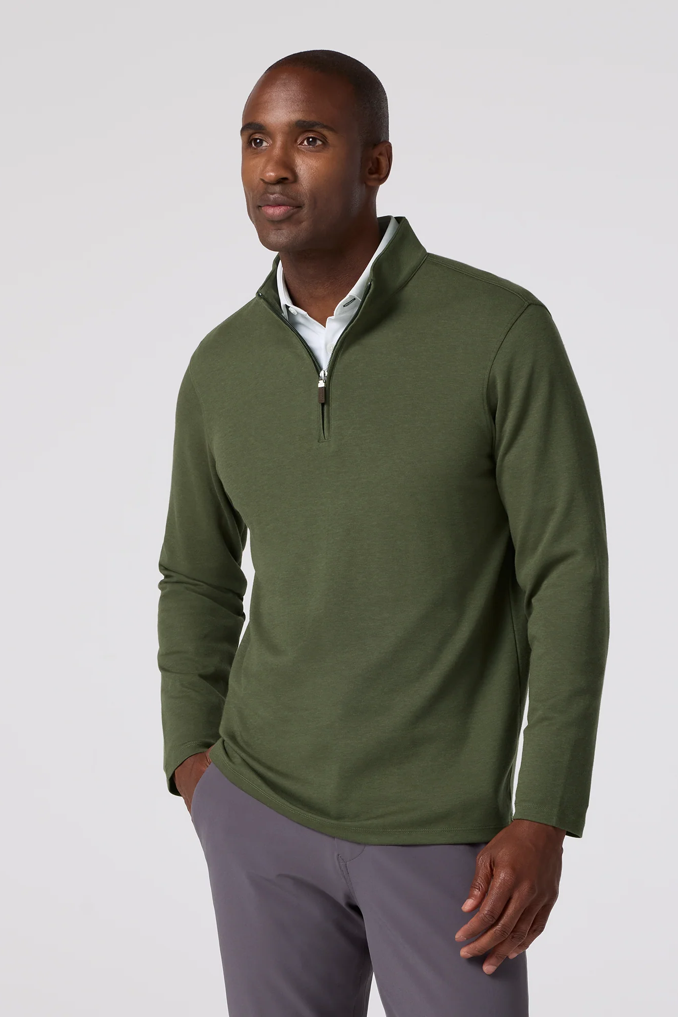 Man wearing a green pullover with a white background