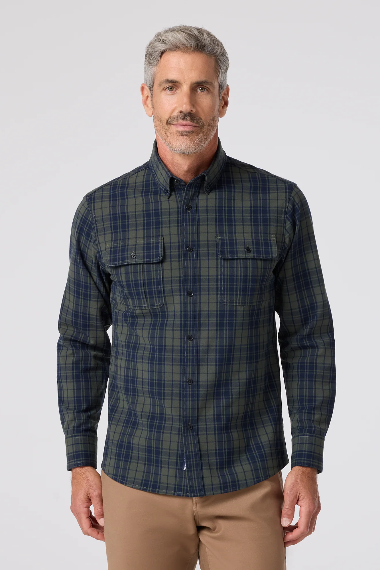 Man wearing a plaid shirt on a white background