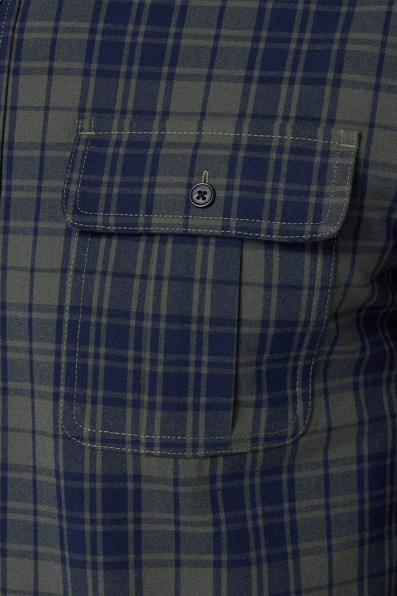 Close-up of a blue and gray plaid shirt with a pocket.