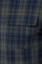 Close-up of a blue and gray plaid shirt with a pocket.