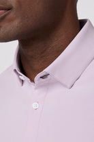 Close-up of a person wearing a light purple dress shirt with a collar detail.