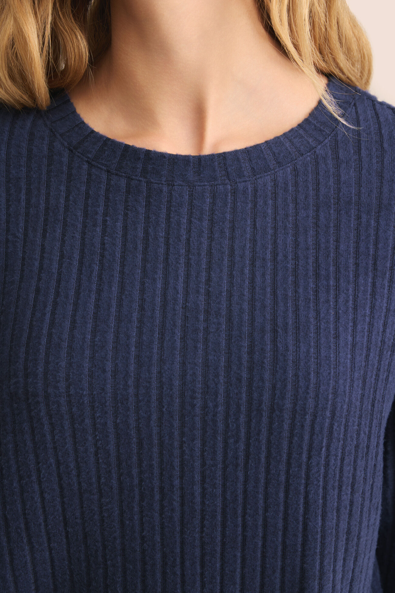 Navy blue ribbed sweater worn by a person