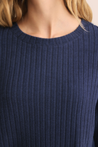 Navy blue ribbed sweater worn by a person