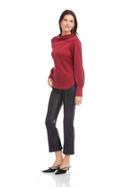 Woman wearing a red sweater and black pants on a white background