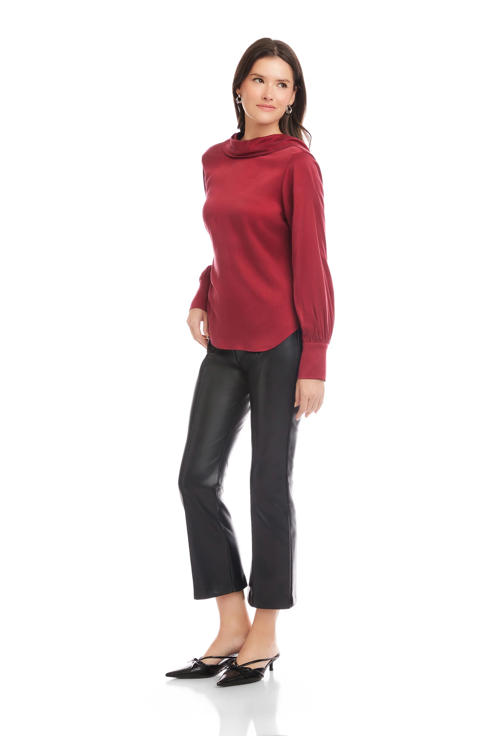 Woman wearing a red sweater and black pants on a white background