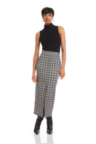 Woman wearing a black turtleneck and plaid skirt on a white background