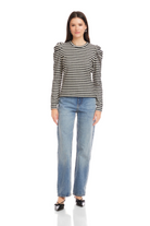 Woman wearing a black and white striped long-sleeve shirt and blue jeans on a white background