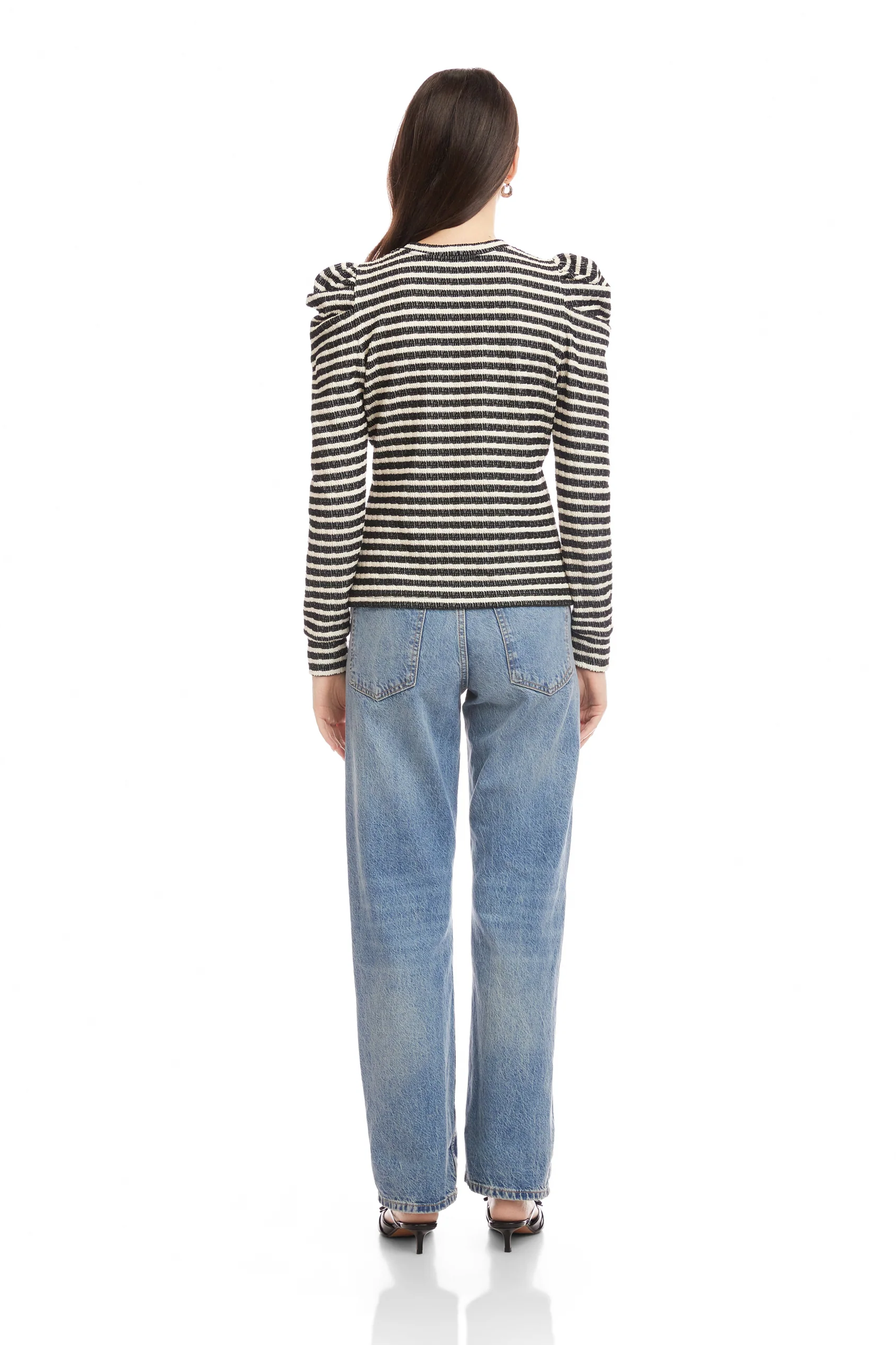 Woman wearing a striped shirt and jeans on a white background