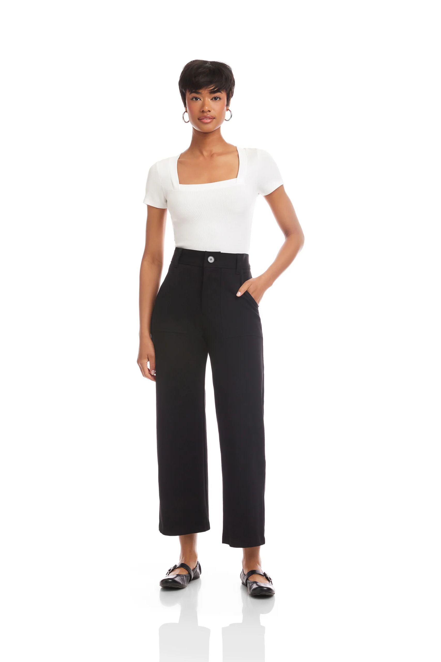 Woman wearing a white top and black pants on a white background