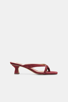 Red sandal with a thin heel on a white background