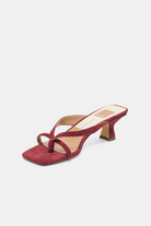 Red sandal with a low heel on a white background