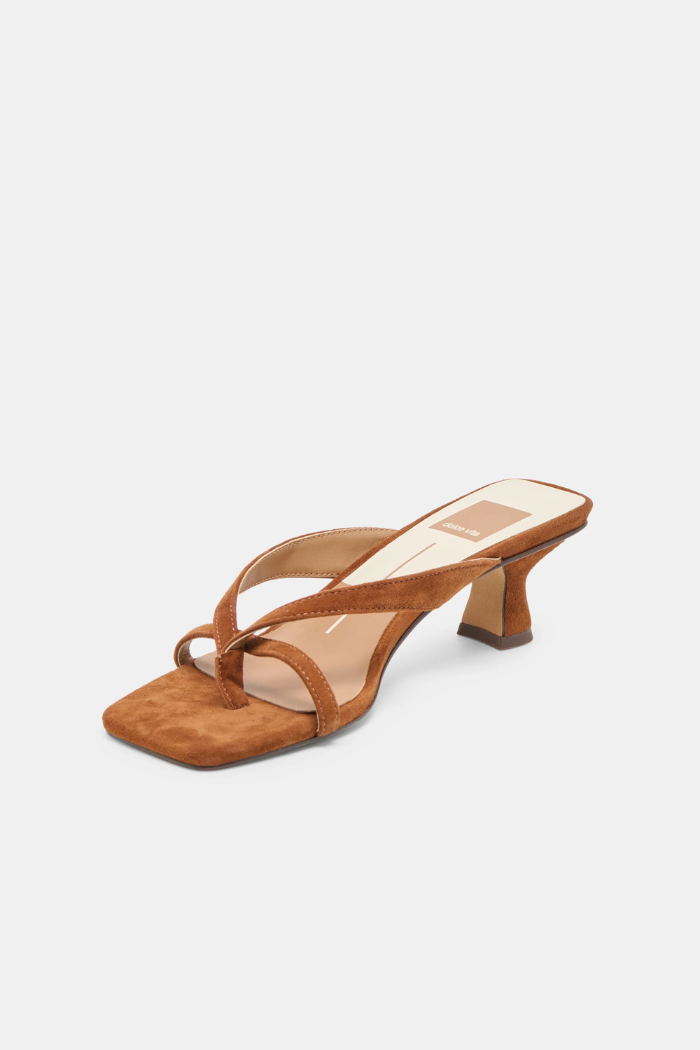 Brown sandal with a high heel on a light gray background