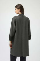 Woman wearing a gray coat on a white background