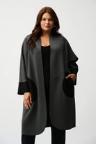 Woman wearing a gray and black coat on a white background