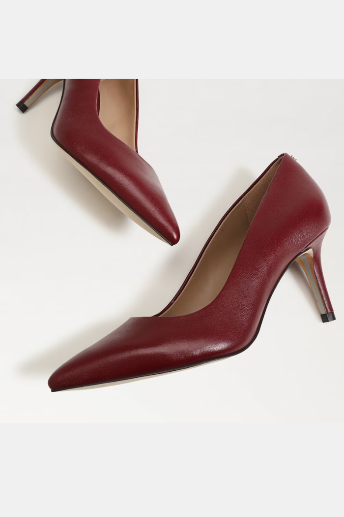 Pair of maroon high-heeled shoes on a white background