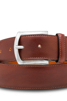 Brown leather belt with a silver buckle on a white background